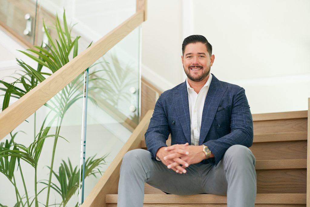 Zach Monger Zach Monger sitting on the steps of a luxury listing
